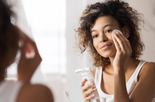 Woman applying skin care products